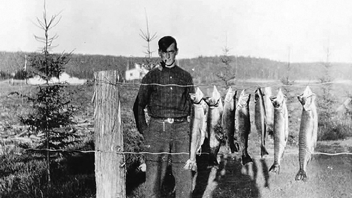 Tom Thomson with a catch of fish