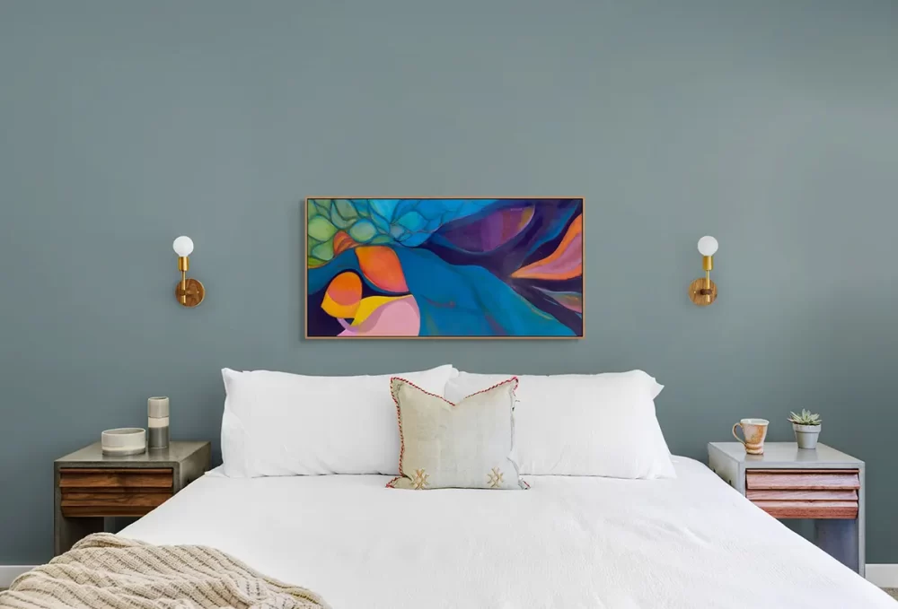 Bright abstract painting over a bed