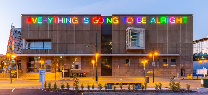 "Everything is gong to be alright" neon sign on museum facade